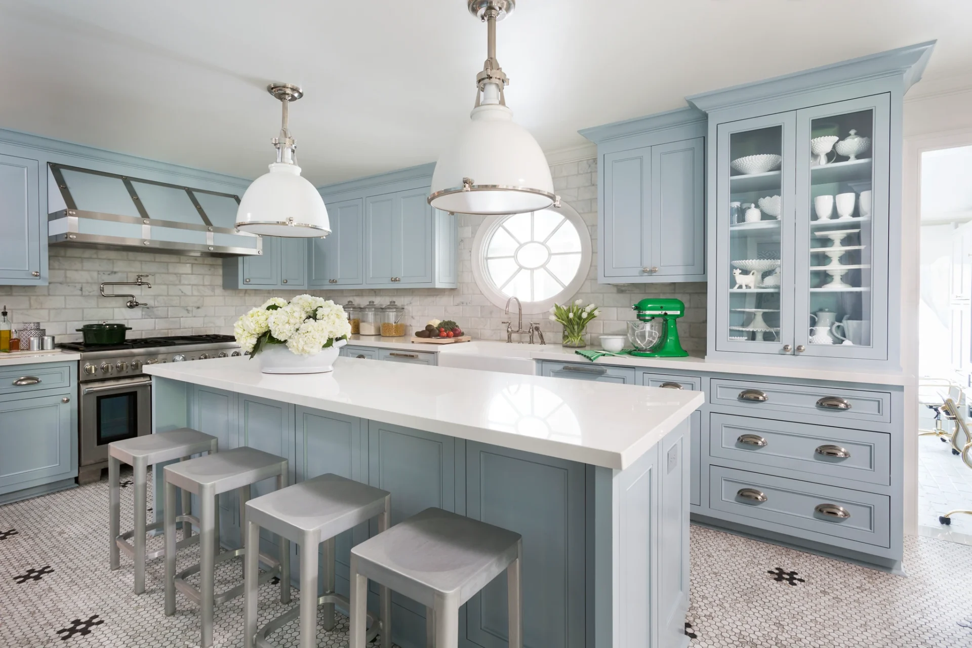 A kitchen with blue cabinets and white counters.