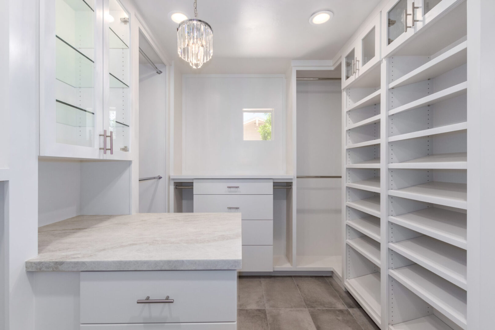 A large white room with shelves and cabinets.