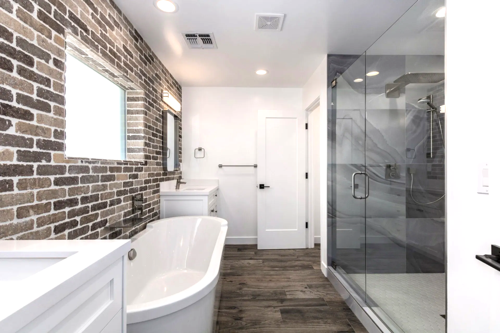 A bathroom with a tub, shower and toilet.