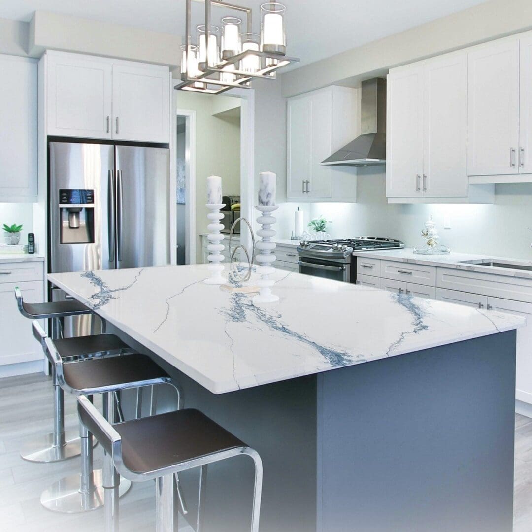 A kitchen with white cabinets and marble counter tops.