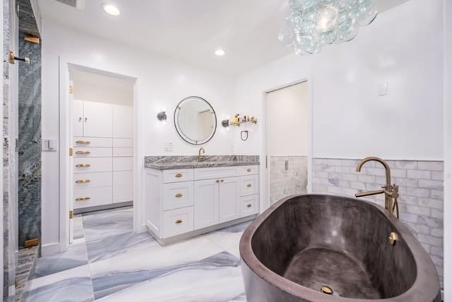 A bathroom with marble floors and walls.